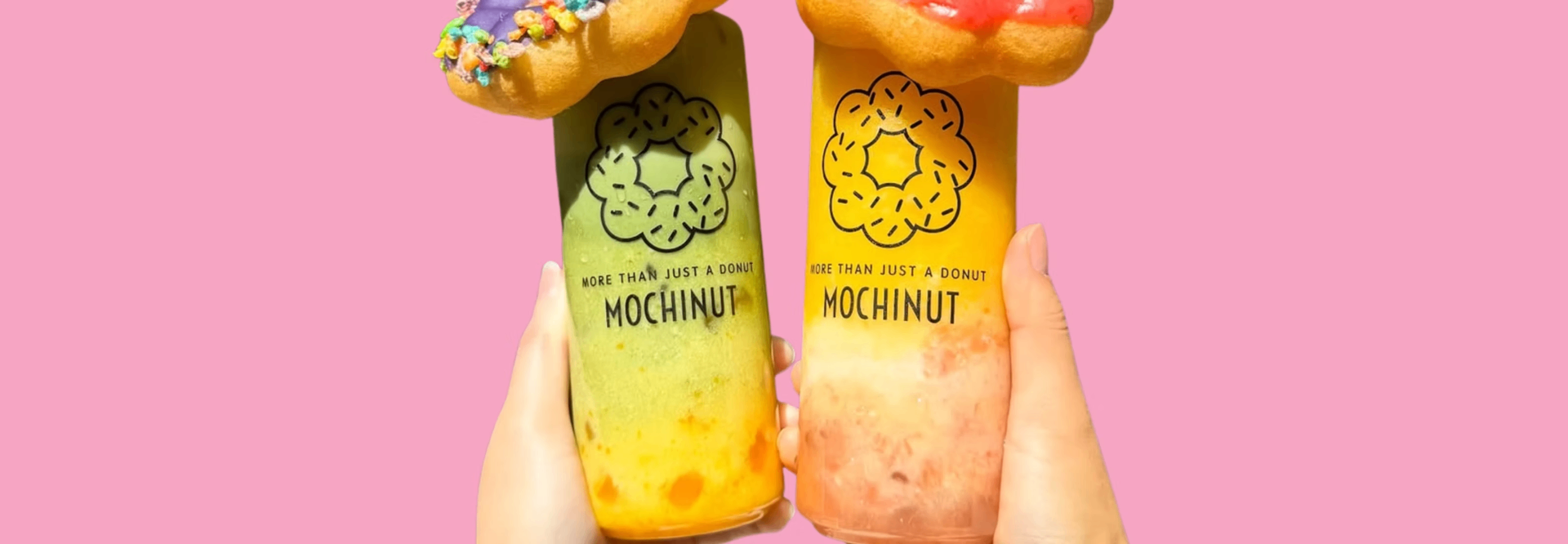 Two colorful Mochinut drinks topped with donuts